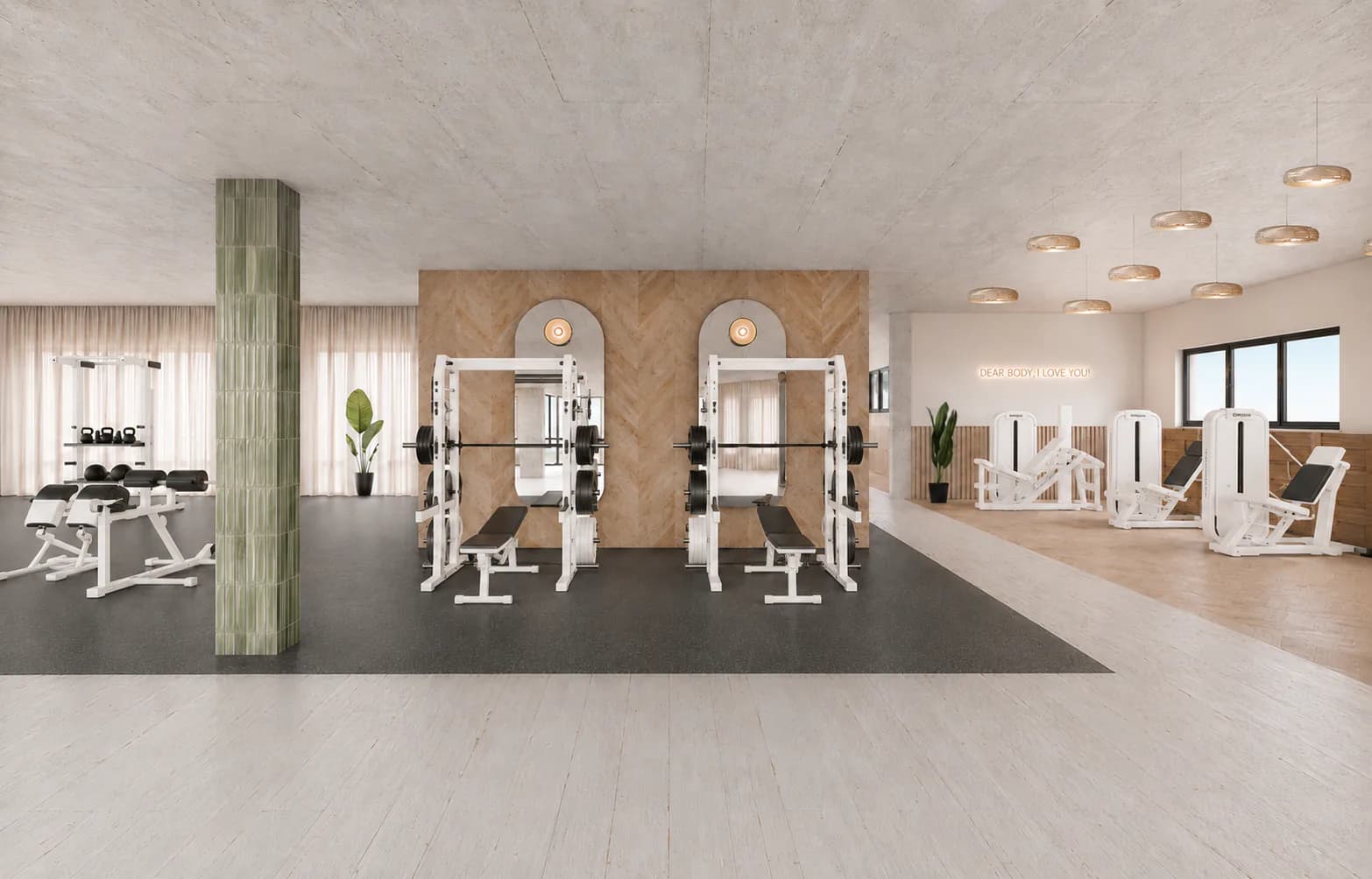 The training floor with strength stations, weight benches and machines by the window